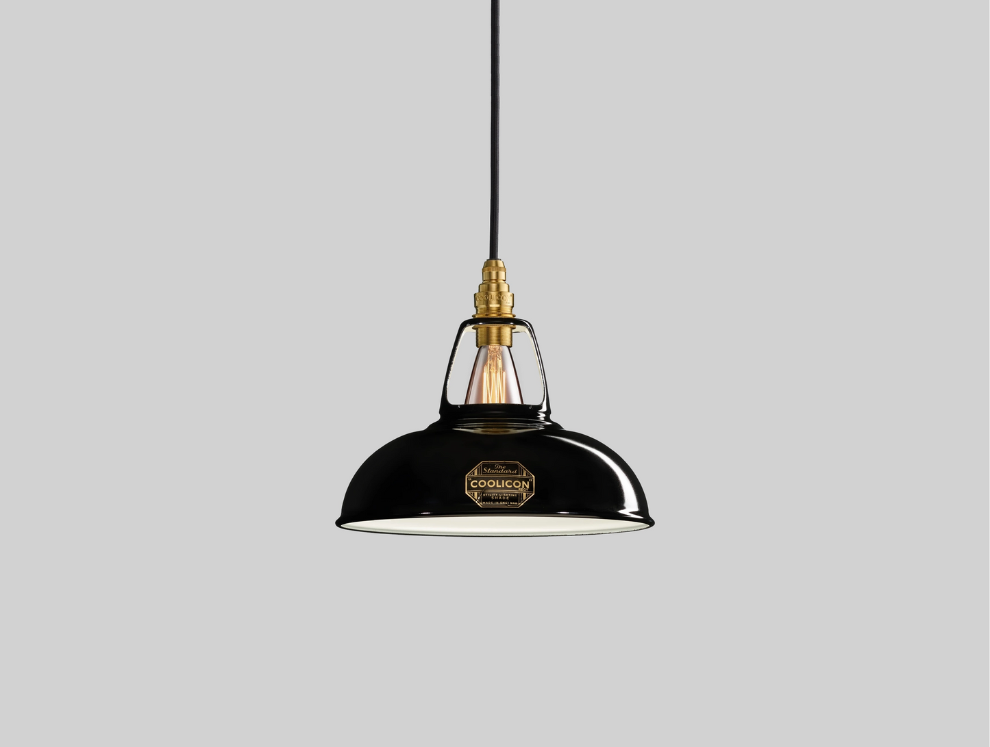 An Original Jet Black shade hanging over a grey background