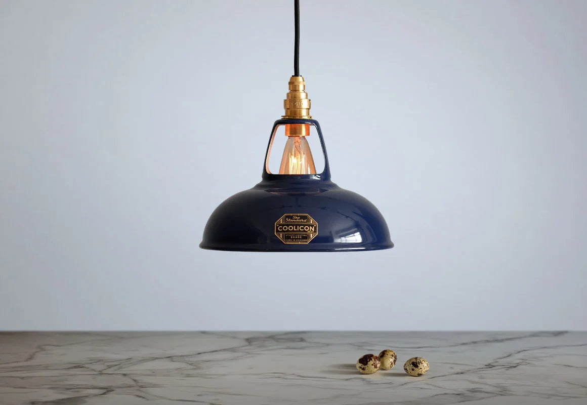 An Original Royal Blue shade hanging over a marble table with quail eggs