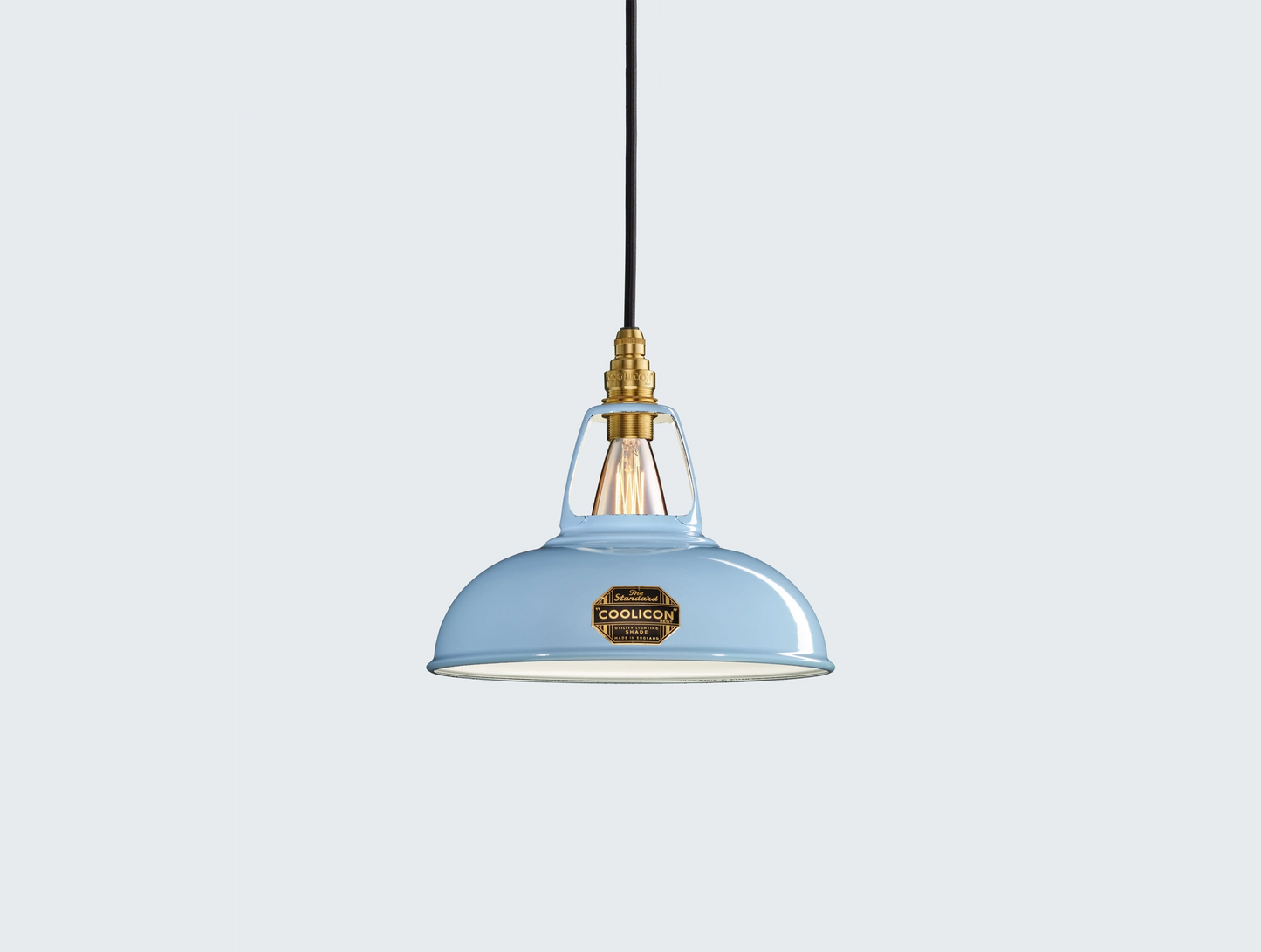 Sky Blue Coolicon lampshade with a Brass pendant set over a light blue background