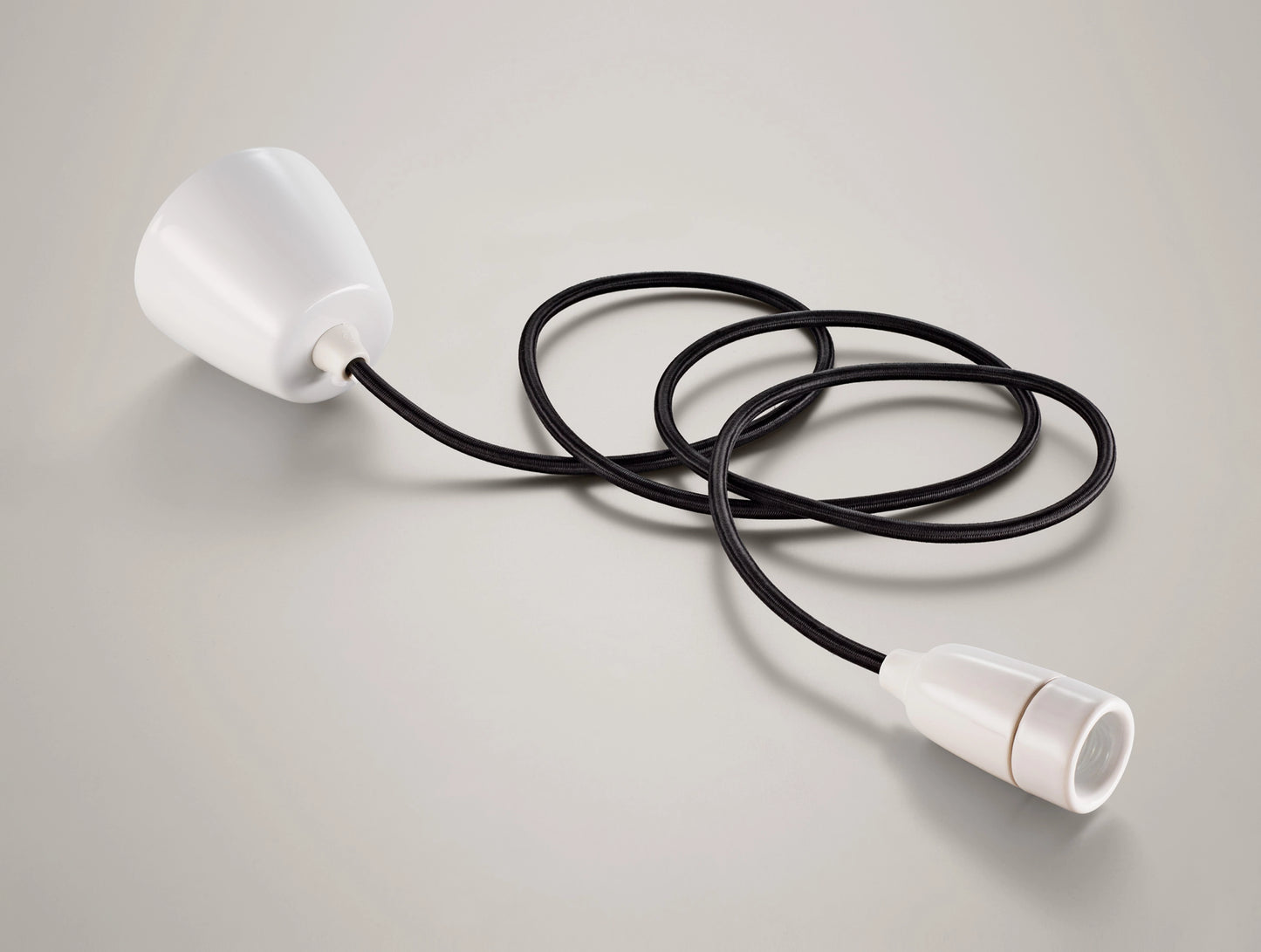 A Coolicon Porcelain pendant set with a white Vitreous Enamel ceiling cup and black cable