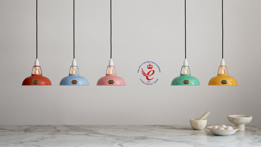 5 Coolicon lampshades hanging in selection of contemporary, bright colours with King's Award for Enterprise logo alongside them