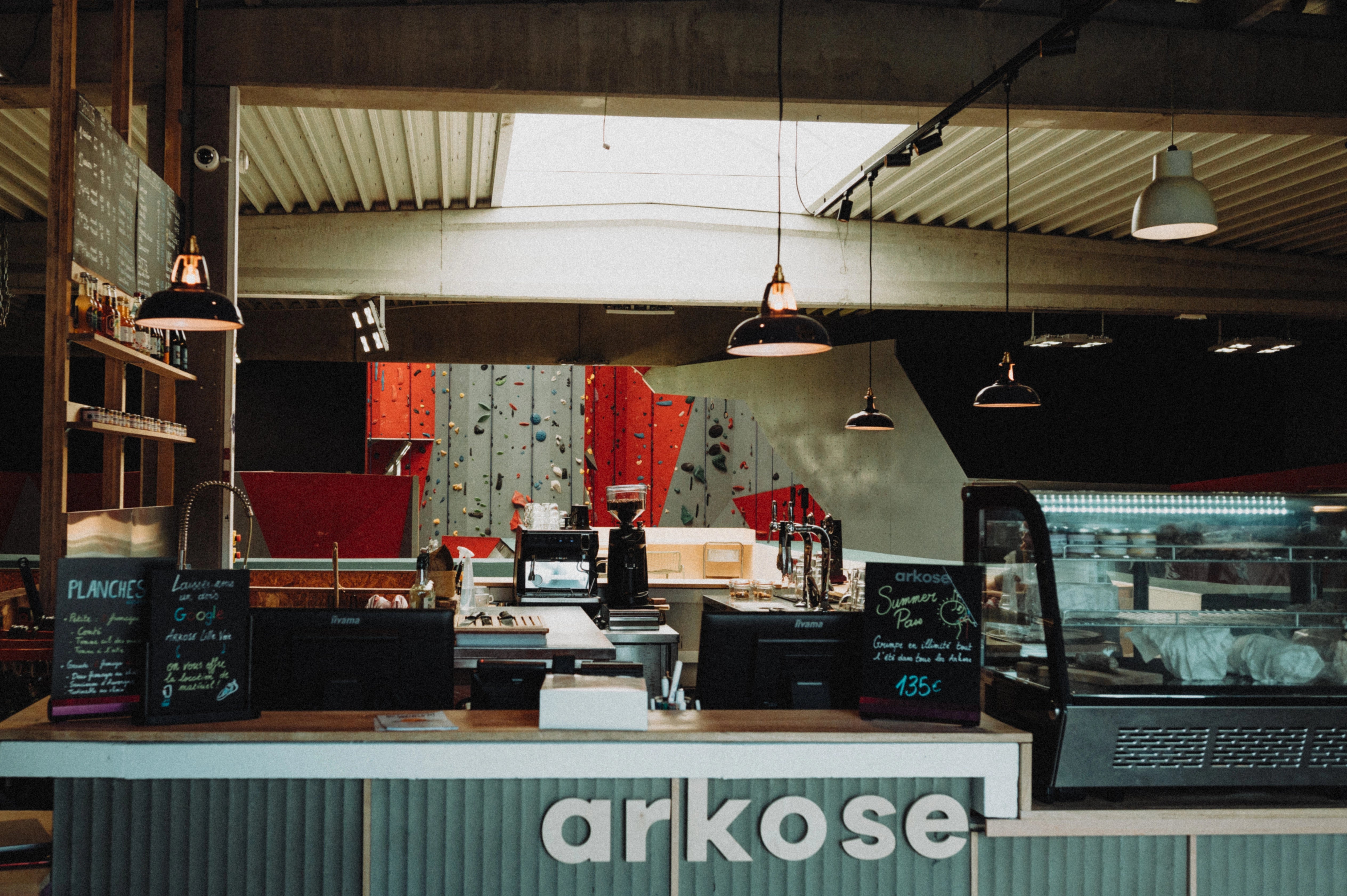 Custom enamel Coolicon pendant lighting adding a vibrant purple accent to Arkose’s reception area