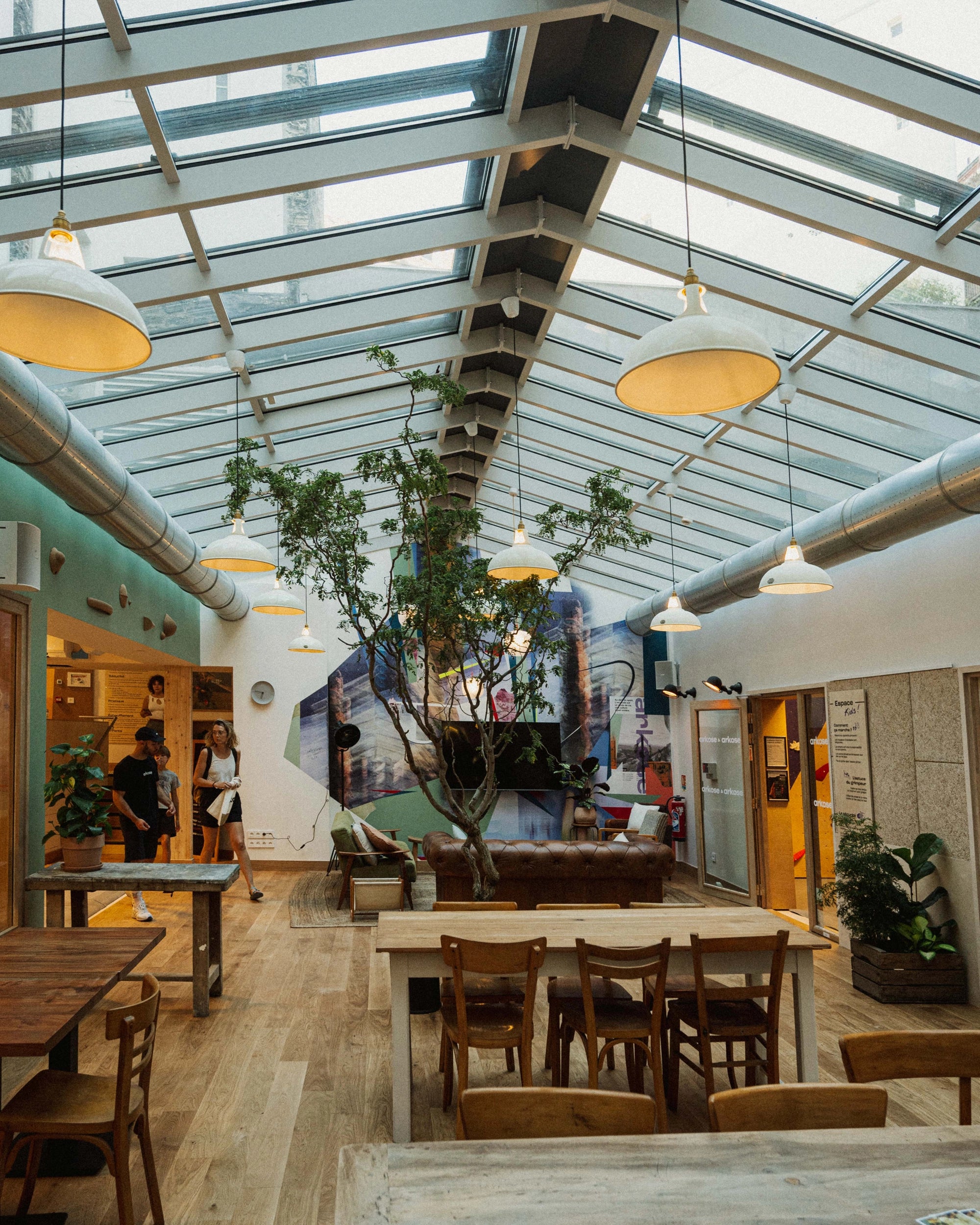 Heritage‑style Coolicon lampshades suspended above café tables in Arkose’s canteen, providing durable commercial lighting for high‑traffic hospitality areas.