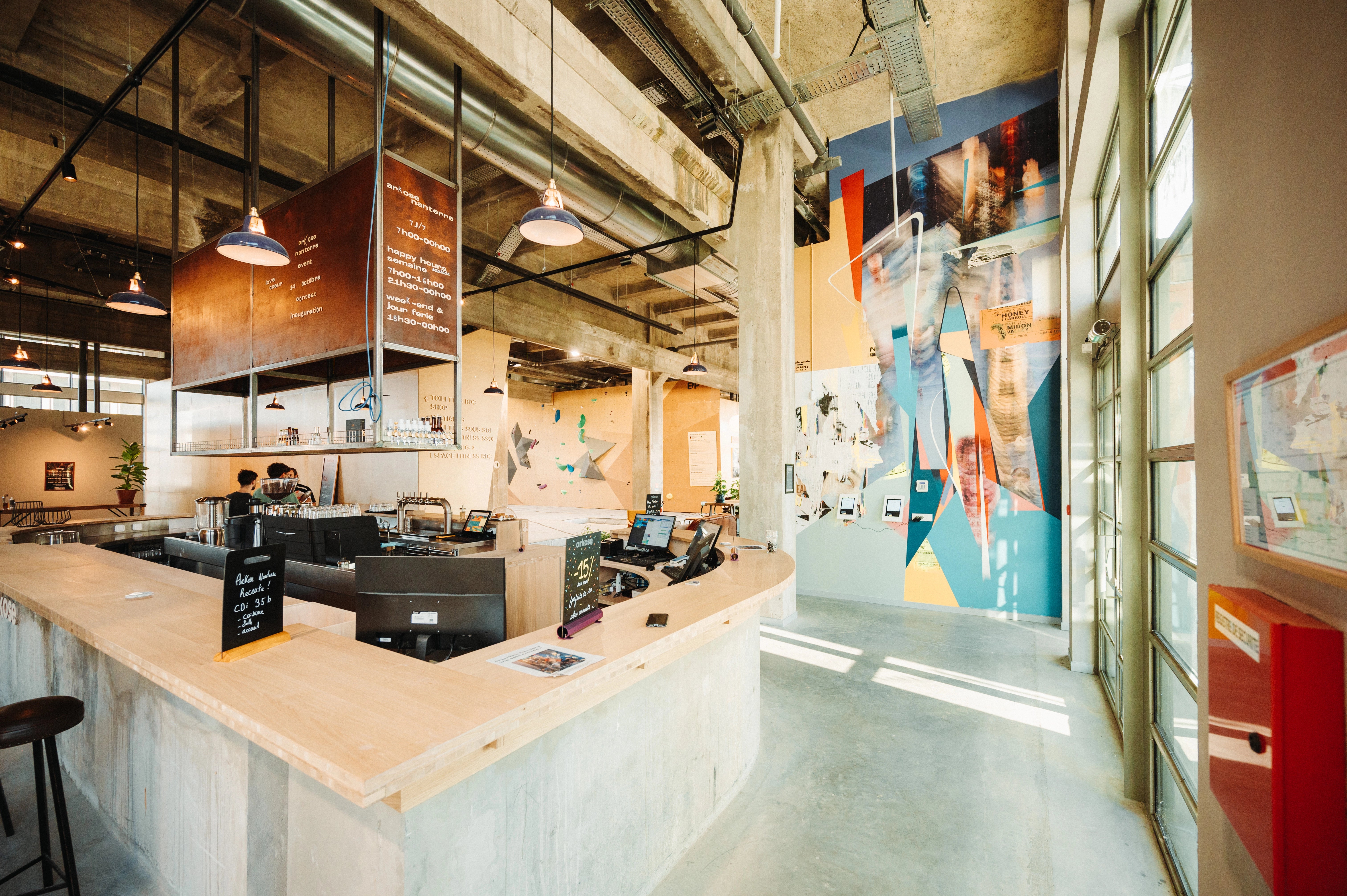 Custom enamel Coolicon pendant lighting adding a vibrant purple accent to Arkose’s timber and concrete interior palette.