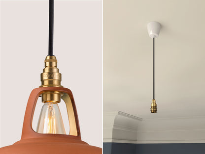 Close up of an E14 Signature Brass suspension set on a Natural Terracotta lampshade on the left. On the right, an E14 Brass pendant set is hanging from the ceiling