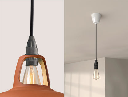 Close up of an E14 Industrial suspension set on a Natural Terracotta lampshade on the left. On the right, an E14 Industrial pendant set with a lightbulb is hanging from the ceiling