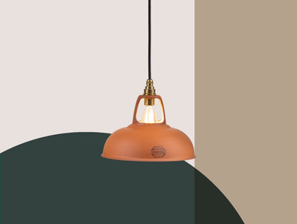 A Natural Terracotta shade  hanging over a colourful geometric background