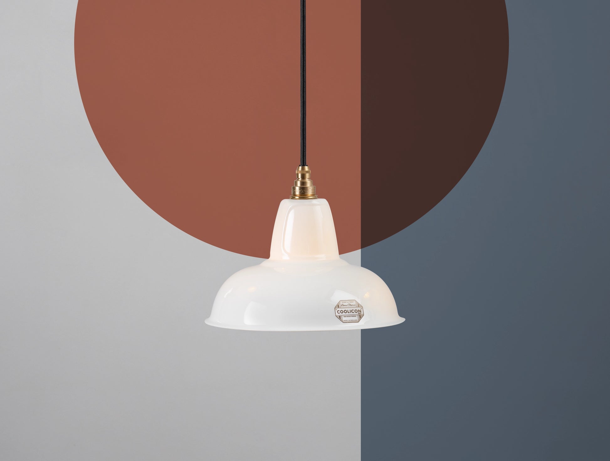 A Fine Bone China Silhouette Coolicon shade hangs over a colourful geometric background