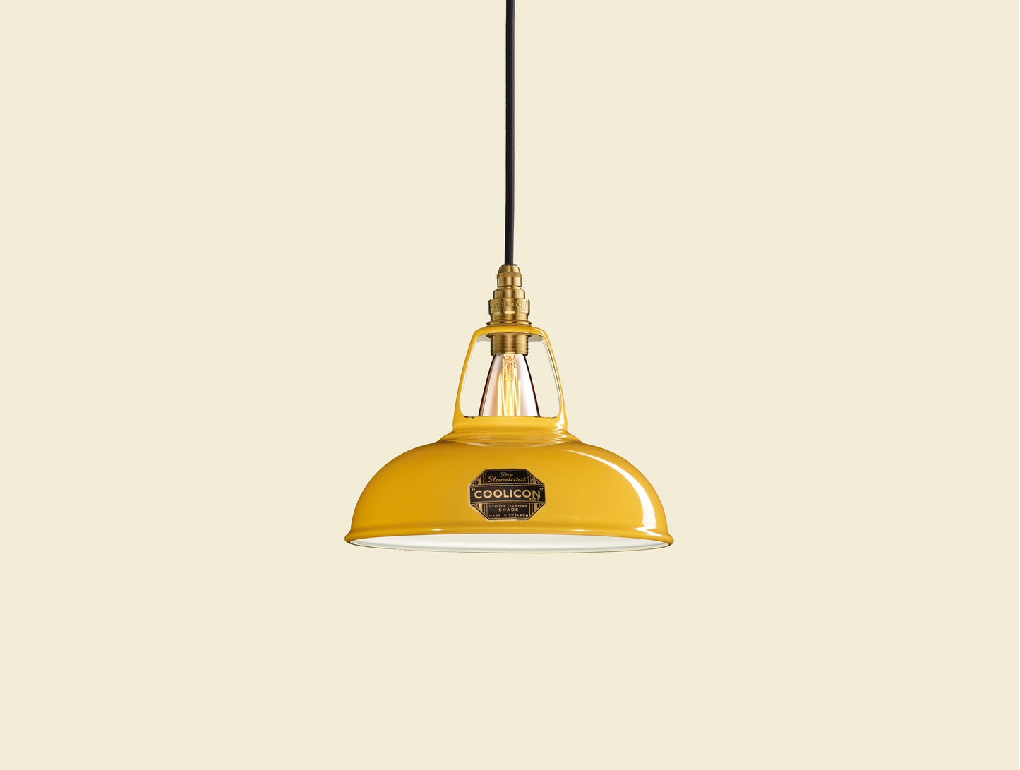 Deep Yellow Coolicon lampshade with a Brass pendant set over a yellow background