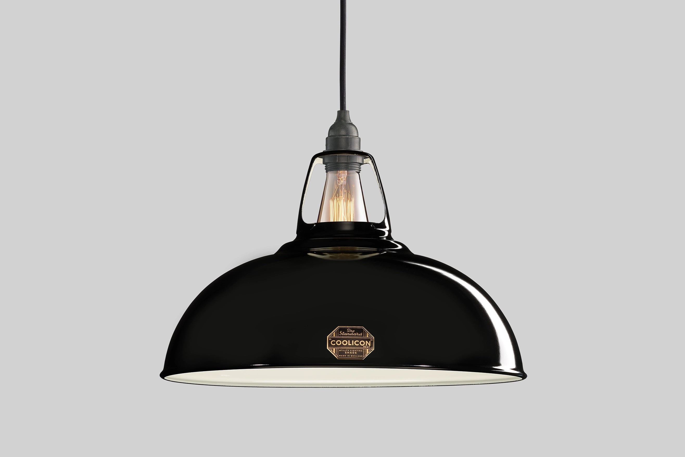 An Large Jet Black shade hanging over a grey background