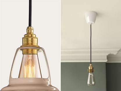 Close up of an E27 Signature Brass suspension set on a Latte Brown lampshade on the left. On the right, an E27 Brass pendant set with a lightbulb is hanging from the ceiling