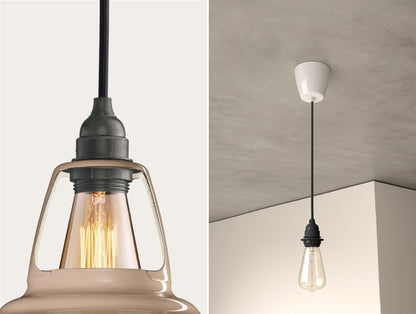 Close up of an E27 Industrial suspension set on a Latte Brown lampshade on the left. On the right, an E27 Industrial pendant set with a lightbulb is hanging from the ceiling