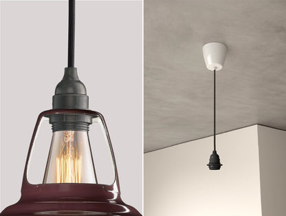 Close up of an E27 Industrial suspension set on a Metropolitan lampshade on the left. On the right, an E27 Industrial pendant set is hanging from the ceiling