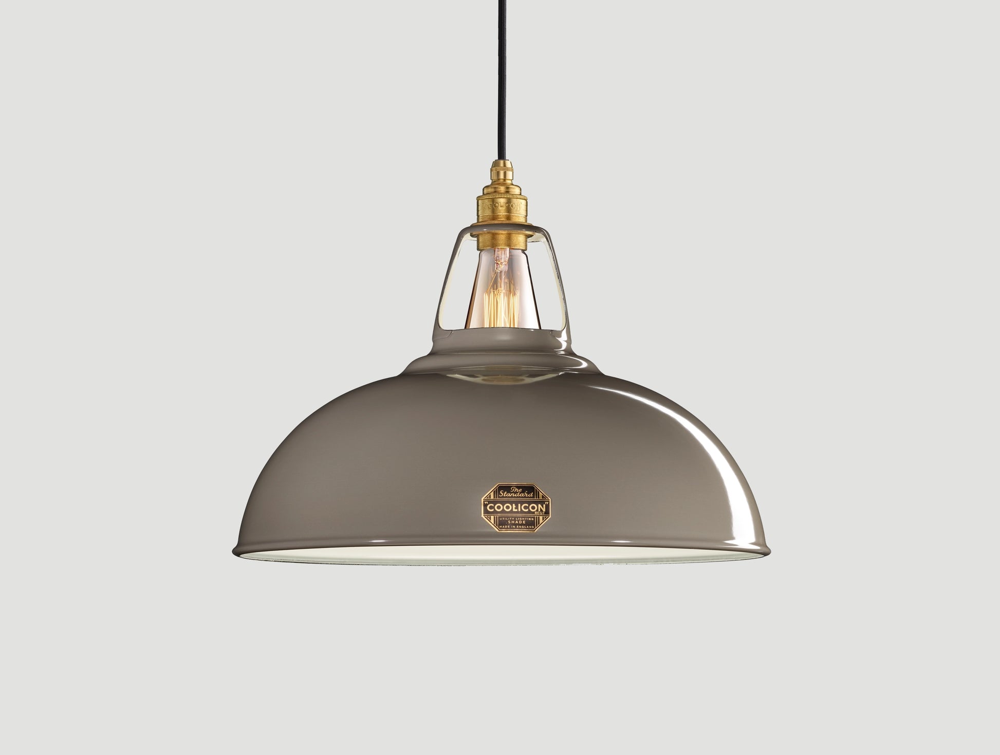 Large Original Grey Coolicon lampshade with a Signature Brass pendant set over a light grey background