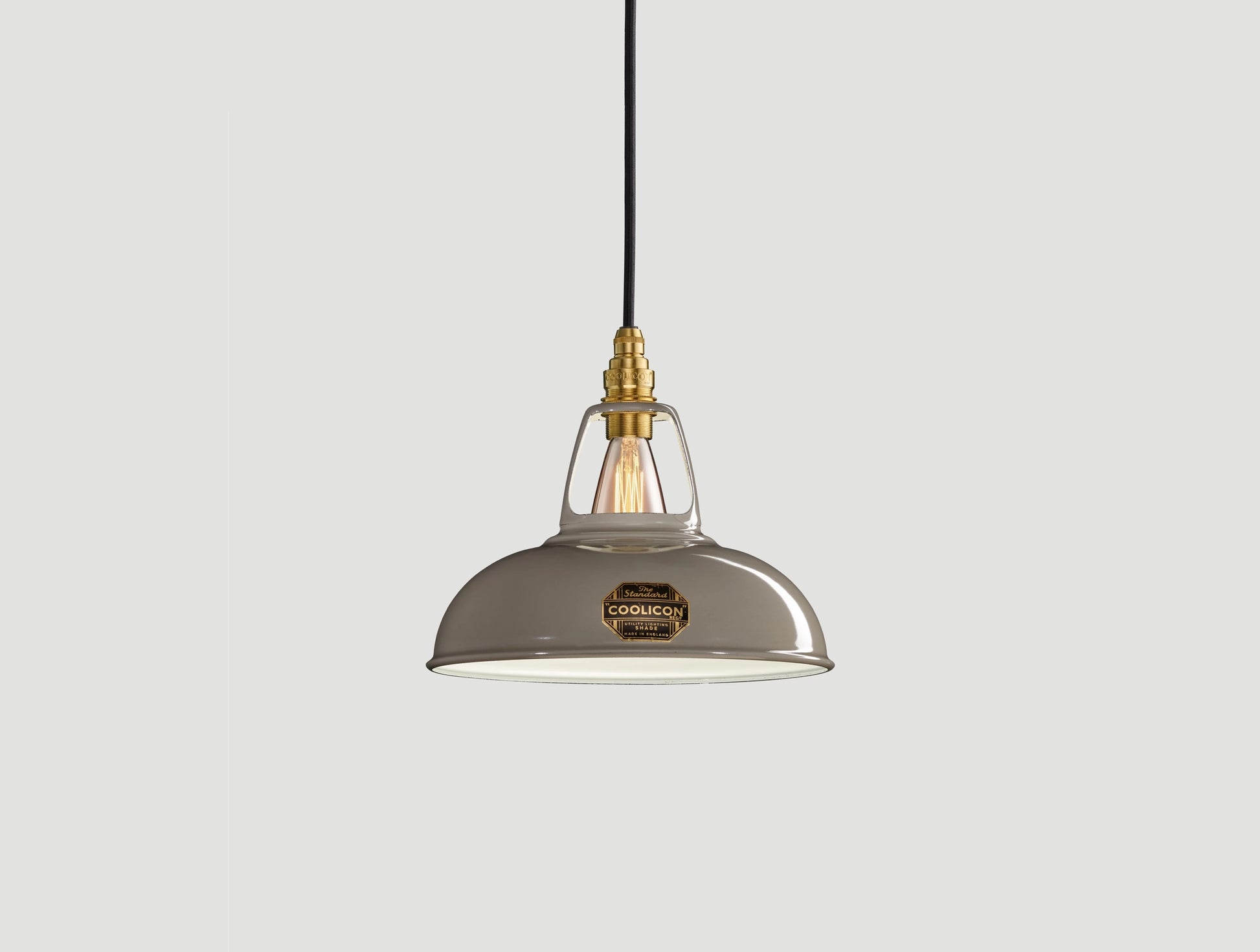 Original Grey Coolicon lampshade with a Signature Brass pendant set over a light grey background