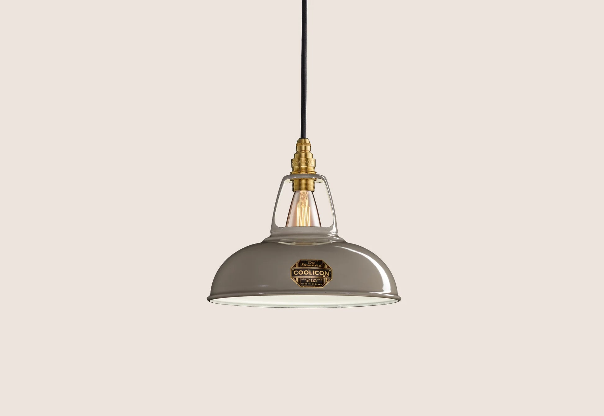 Original Grey Coolicon lampshade with a Signature Brass pendant set over a light grey background