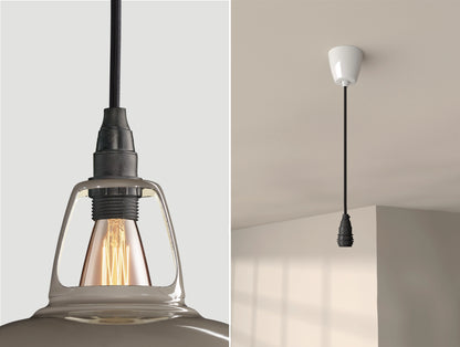 Close up of an E14 Industrial suspension set on an Original Grey lampshade on the left. On the right, an E14 Industrial pendant set is hanging from the ceiling