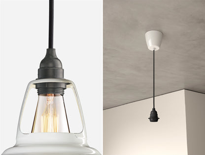 Close up of an E27 Industrial suspension set on a Original White lampshade on the left. On the right, an E27 Industrial pendant set is hanging from the ceiling