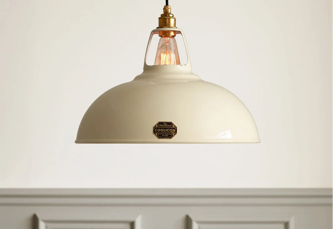 A Large Coolicon Classic Cream lampshade hanging over a cream wall with grey moulding