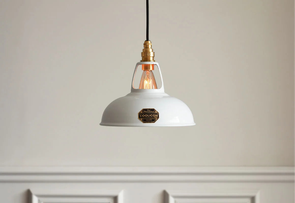 A Coolicon Original White lampshade hanging over a light cream wall with white moulding