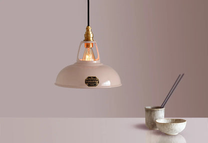 A Coolicon Latte Brown lampshade with a Signature Brass pendant set hanging above a table with a bowl, a cup and chopsticks