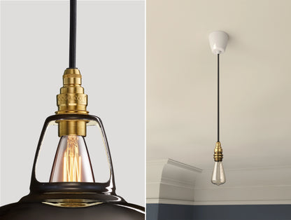 Close up of an E14 Signature Brass suspension set on a Pewter lampshade on the left. On the right, an E14 Brass pendant set with a lightbulb is hanging from the ceiling