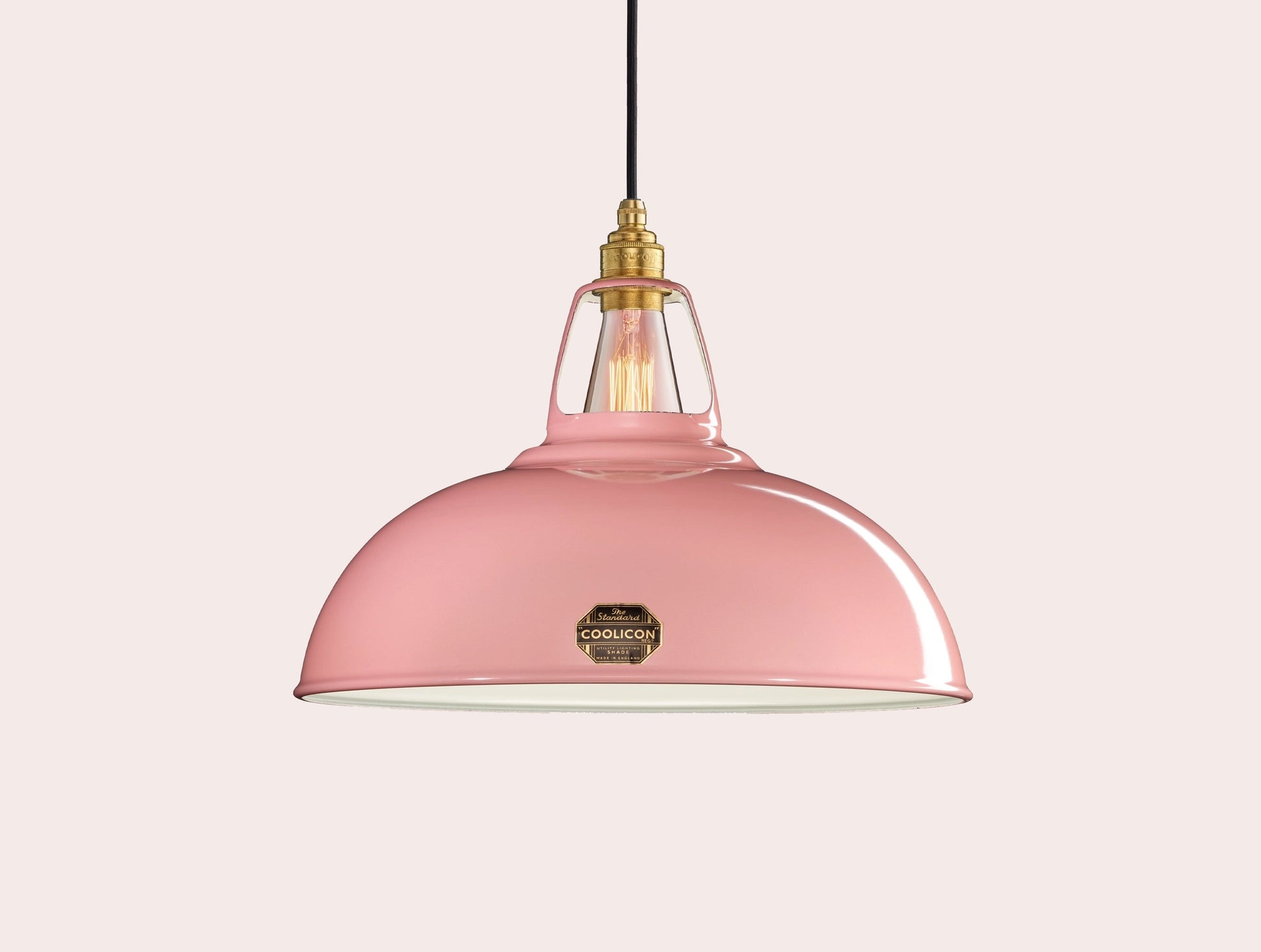 Large Powder Pink Coolicon lampshade with a Brass pendant set over a light pink background
