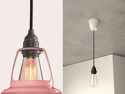 Close up of an E27 Industrial suspension set on a Powder Pink lampshade on the left. On the right, an E27 Industrial pendant set with a lightbulb is hanging from the ceiling