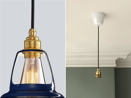 Close up of an E27 Brass suspension set on a Piccadilly Line Blue lampshade on the left. On the right, an E27 Industrial pendant set is hanging from the ceiling