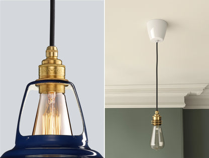 Close up of an E27 Brass suspension set on a Piccadilly Line Blue lampshade on the left. On the right, an E27 Industrial pendant set with a lightbulb is hanging from the ceiling