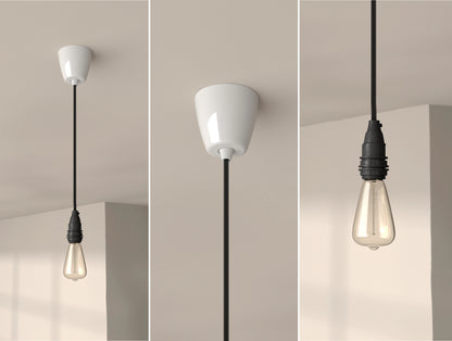 An E14 Industrial Coolicon pendant set with a Vitreous Enamel ceiling cup and an E14 lightbulb hanging from a concrete ceiling