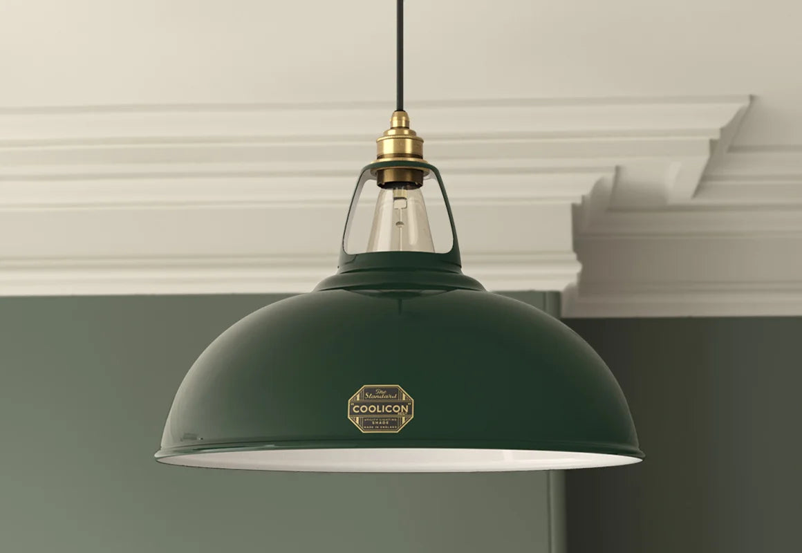 A Large Original Green lampshade with a Coolicon Signature Brass pendant set hanging from the ceiling
