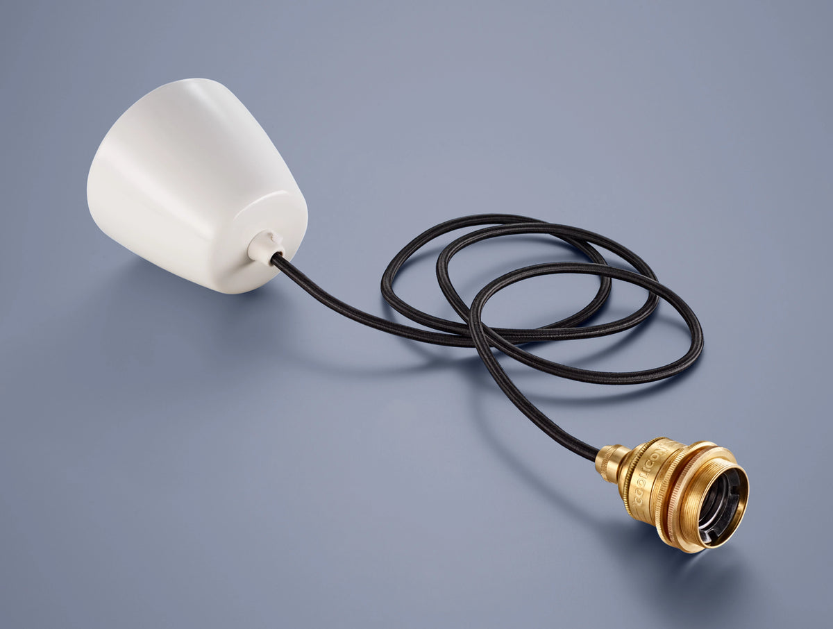 A Coolicon Signature Brass pendant set with a white Vitreous Enamel ceiling cup and black over braided fabric cable and weight bearing steel supporting cable