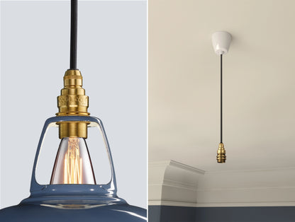Close up of an E14 Signature Brass suspension set on a Selvedge lampshade on the left. On the right, an E14 Brass pendant set is hanging from the ceiling