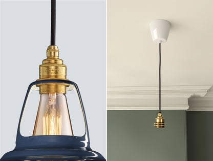 Close up of an E27 Signature Brass suspension set on a Selvedge lampshade on the left. On the right, an E27 Brass pendant set is hanging from the ceiling