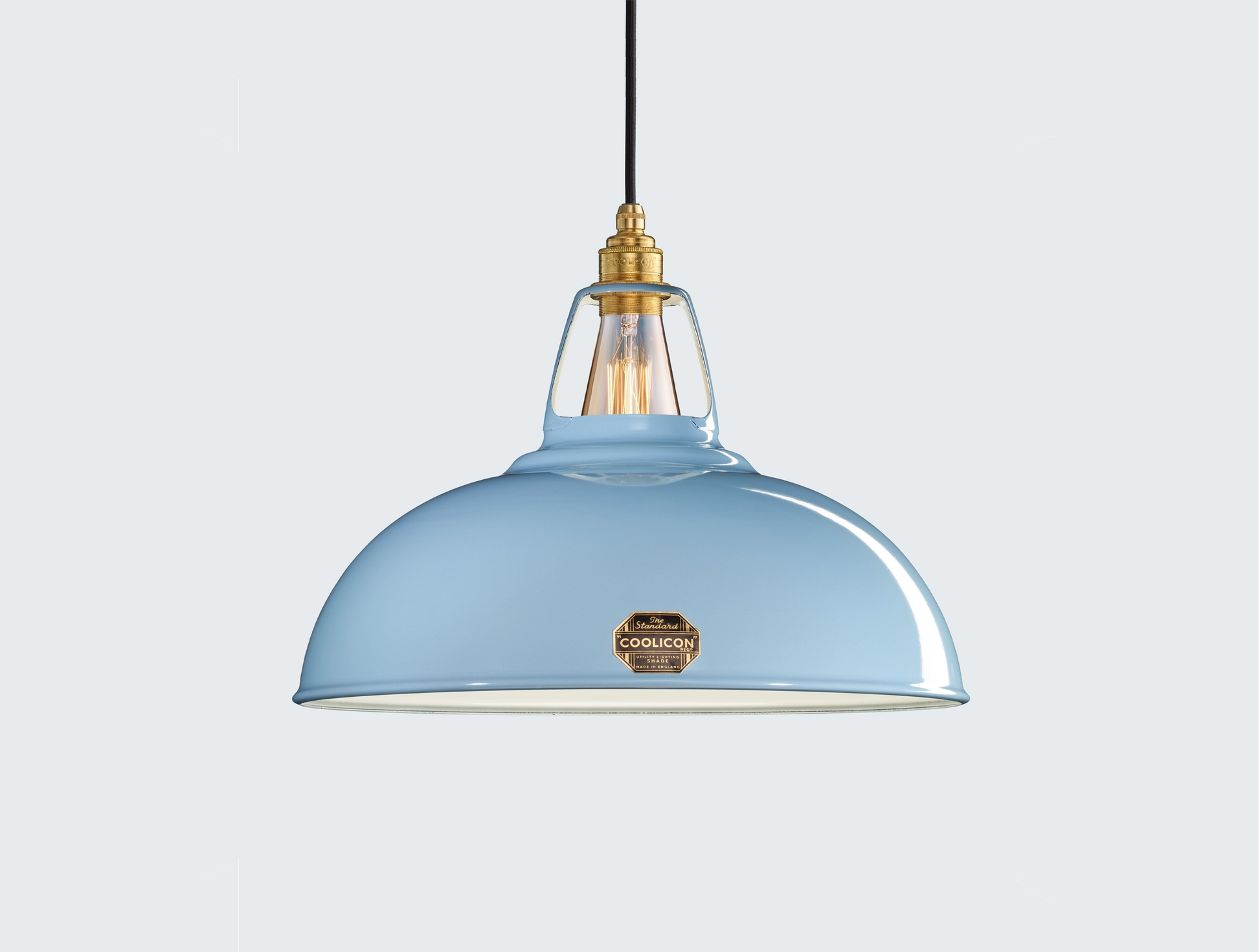 Large Sky Blue Coolicon lampshade with a Brass pendant set over a light blue background