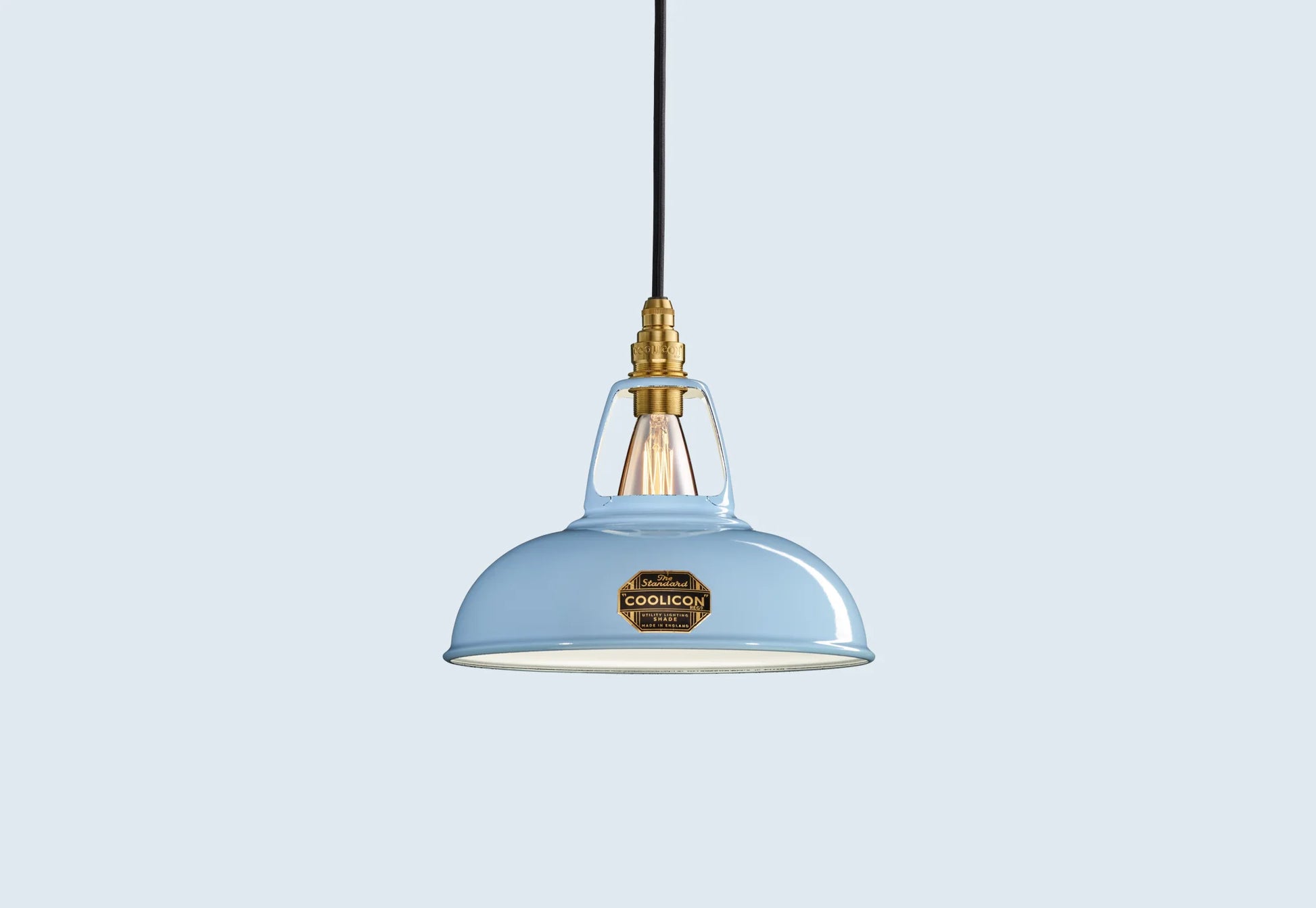 Sky Blue Coolicon lampshade with a Brass pendant set over a light blue background