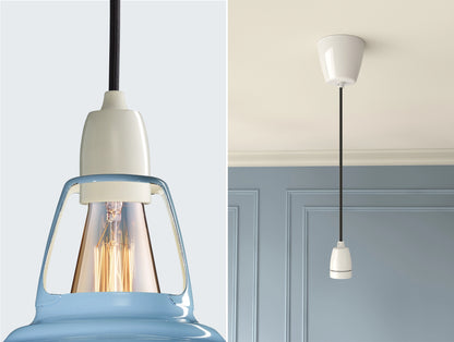 Close up of an E27 Signature Brass suspension set on a Sky Blue lampshade on the left. On the right, an E27 Brass pendant set is hanging from the ceiling