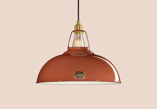 Large Terracotta Coolicon lampshade with a Brass pendant set over a light teal background