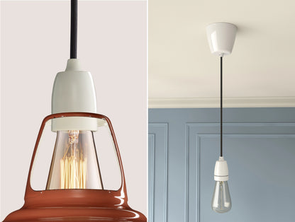 Close up of an E27 Porcelain suspension set on a Terracotta lampshade on the left. On the right, an E27 Porcelain pendant set with a lightbulb is hanging from the ceiling