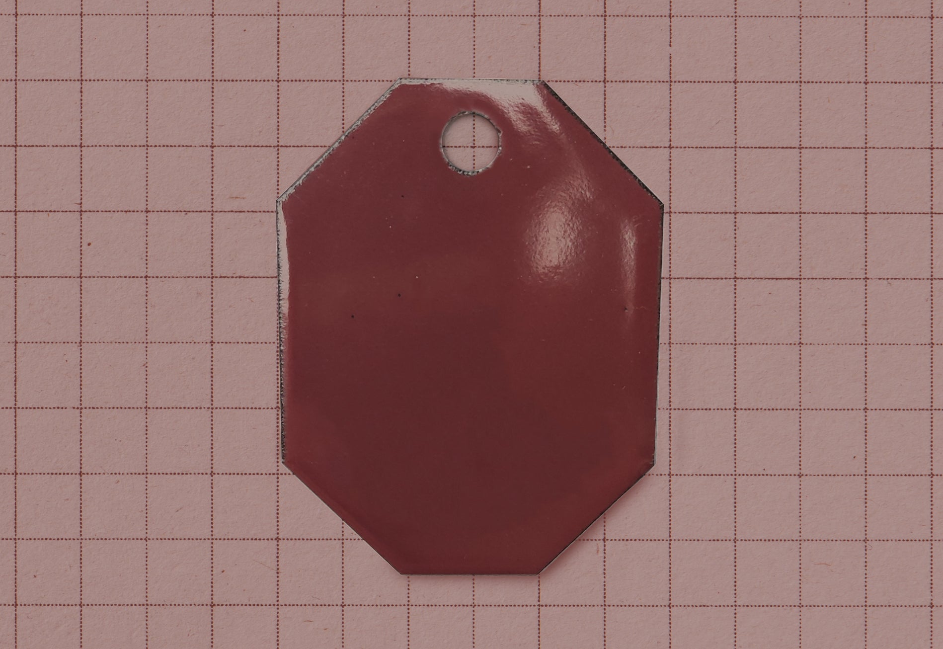 A vitreous enamel colour sample of the colour Metropolitan from Coolicon Lighting. This is a rich burgundy and maroon colour.