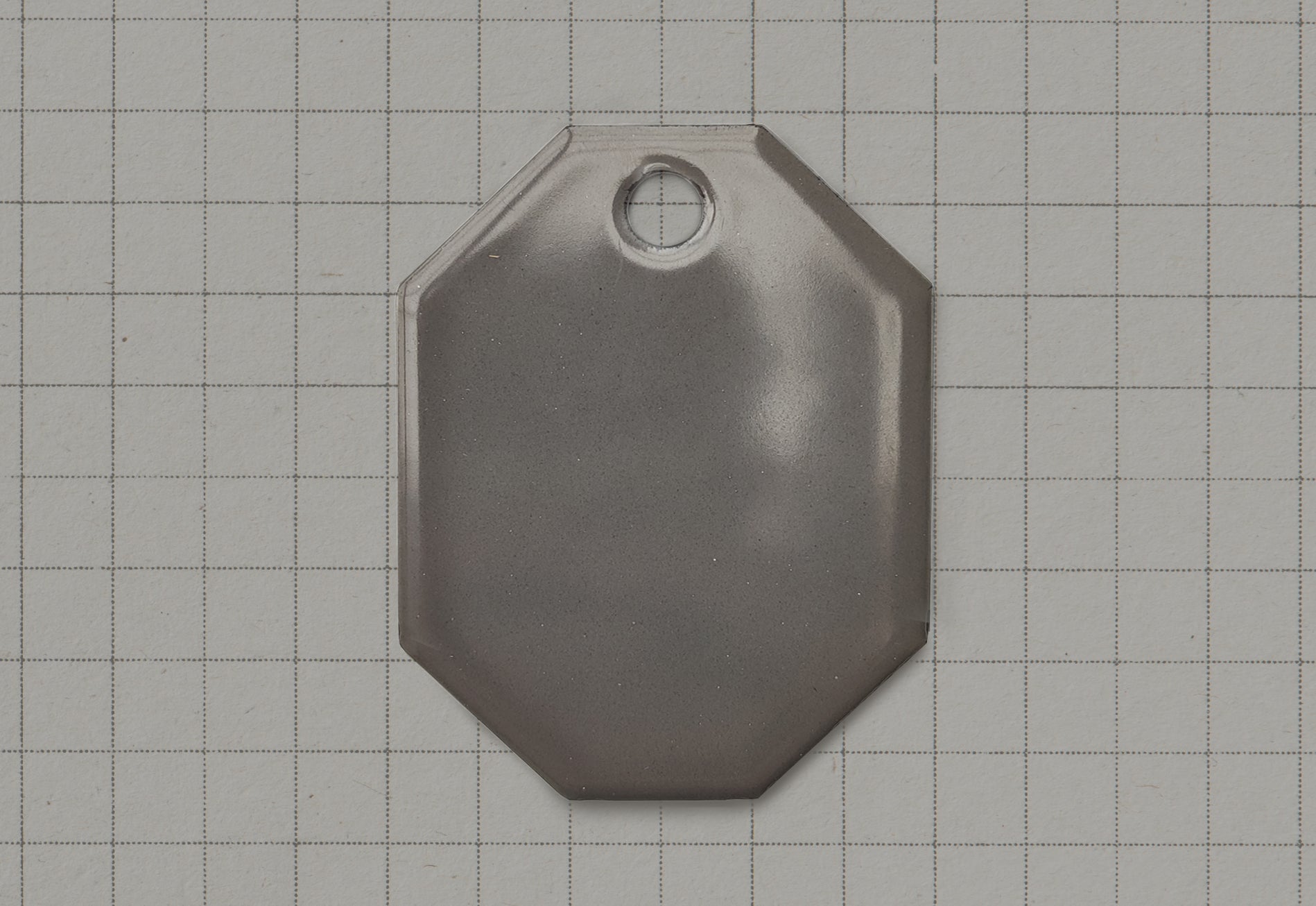 A vitreous enamel colour sample of the colour Original Grey from Coolicon Lighting