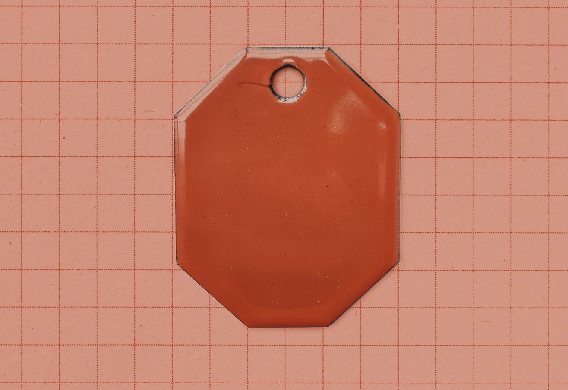 A vitreous enamel colour sample of the colour Terracotta from Coolicon Lighting