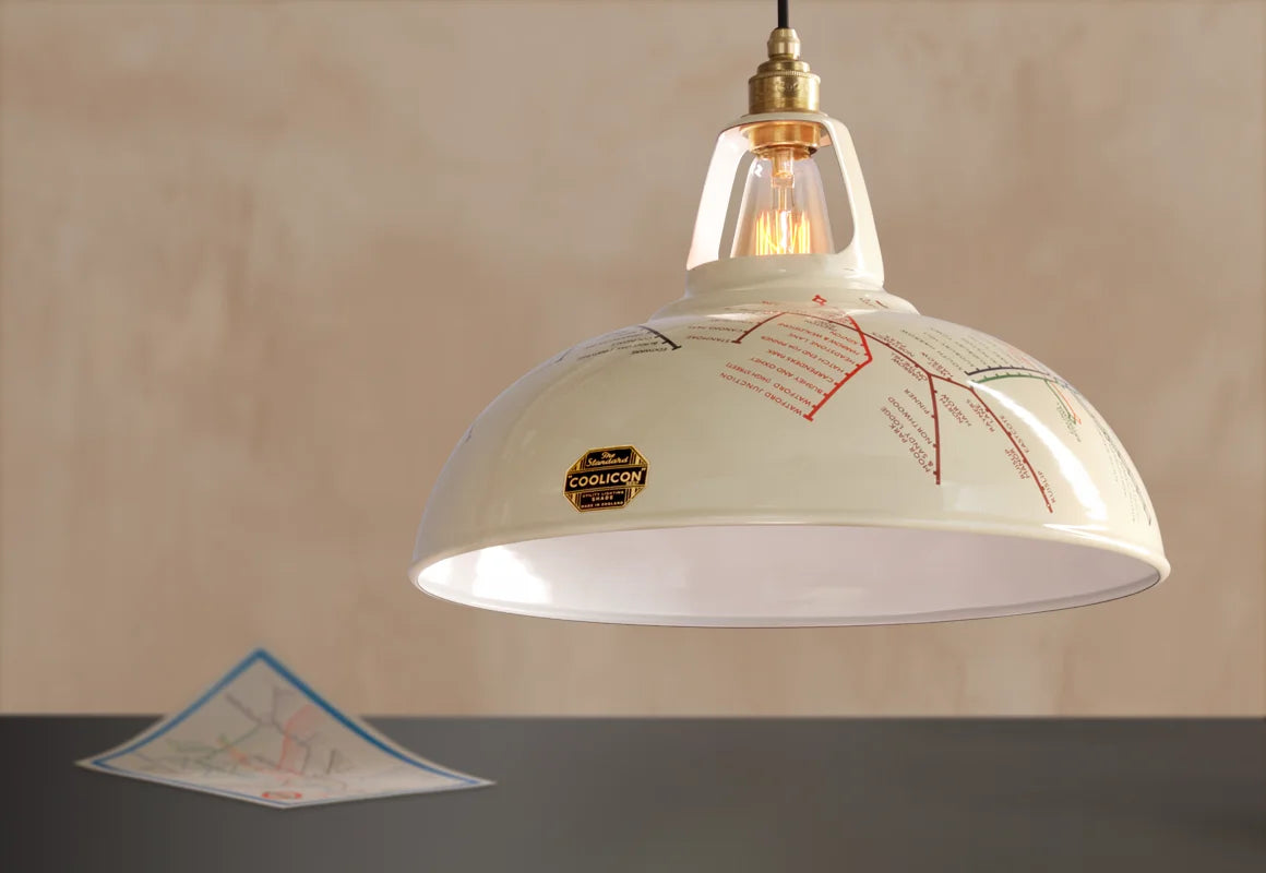 A Large Underground Map shade hanging over a table with a 1933 map.