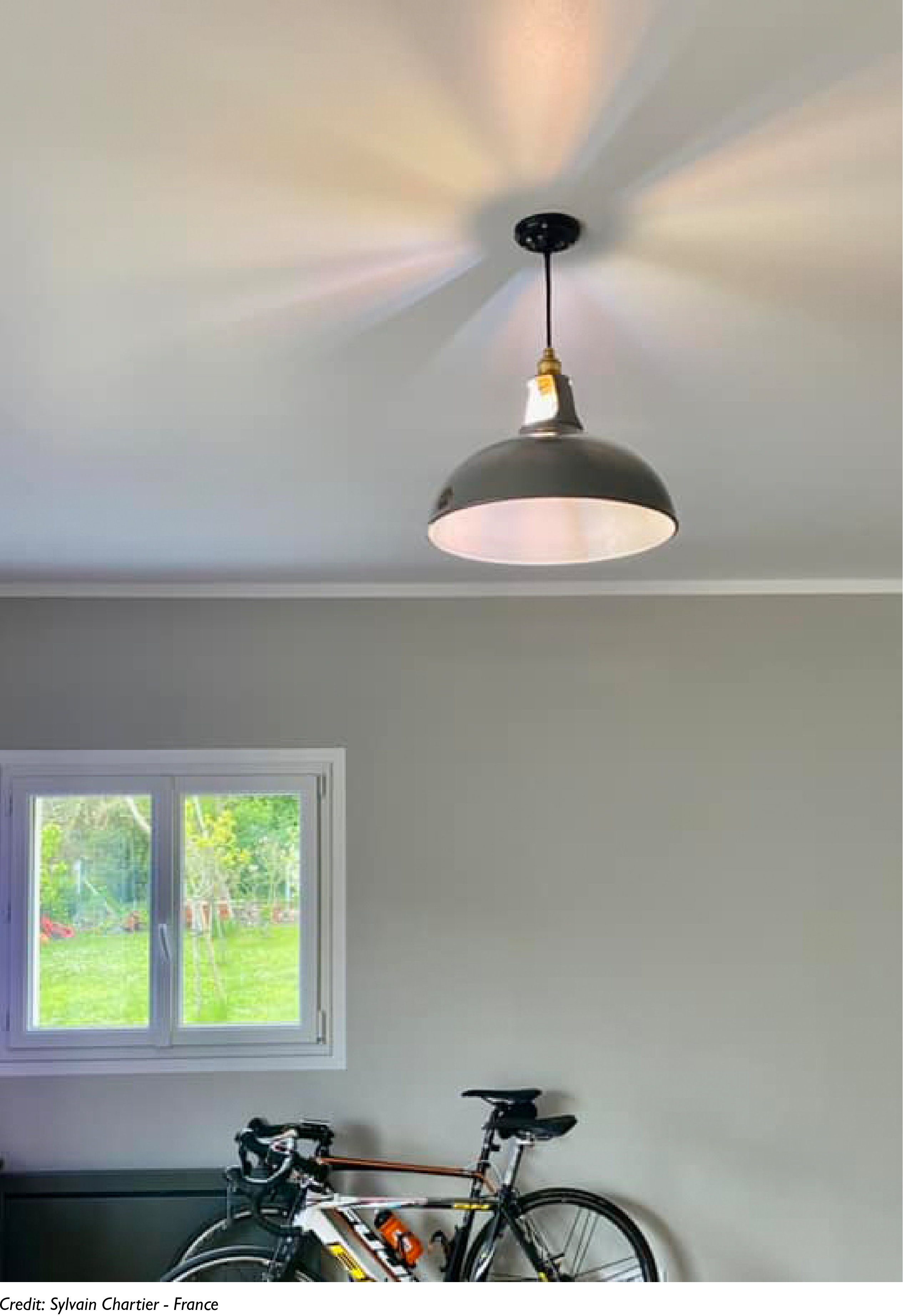 A Large Antinium lamp casts a colourful light on the ceiling