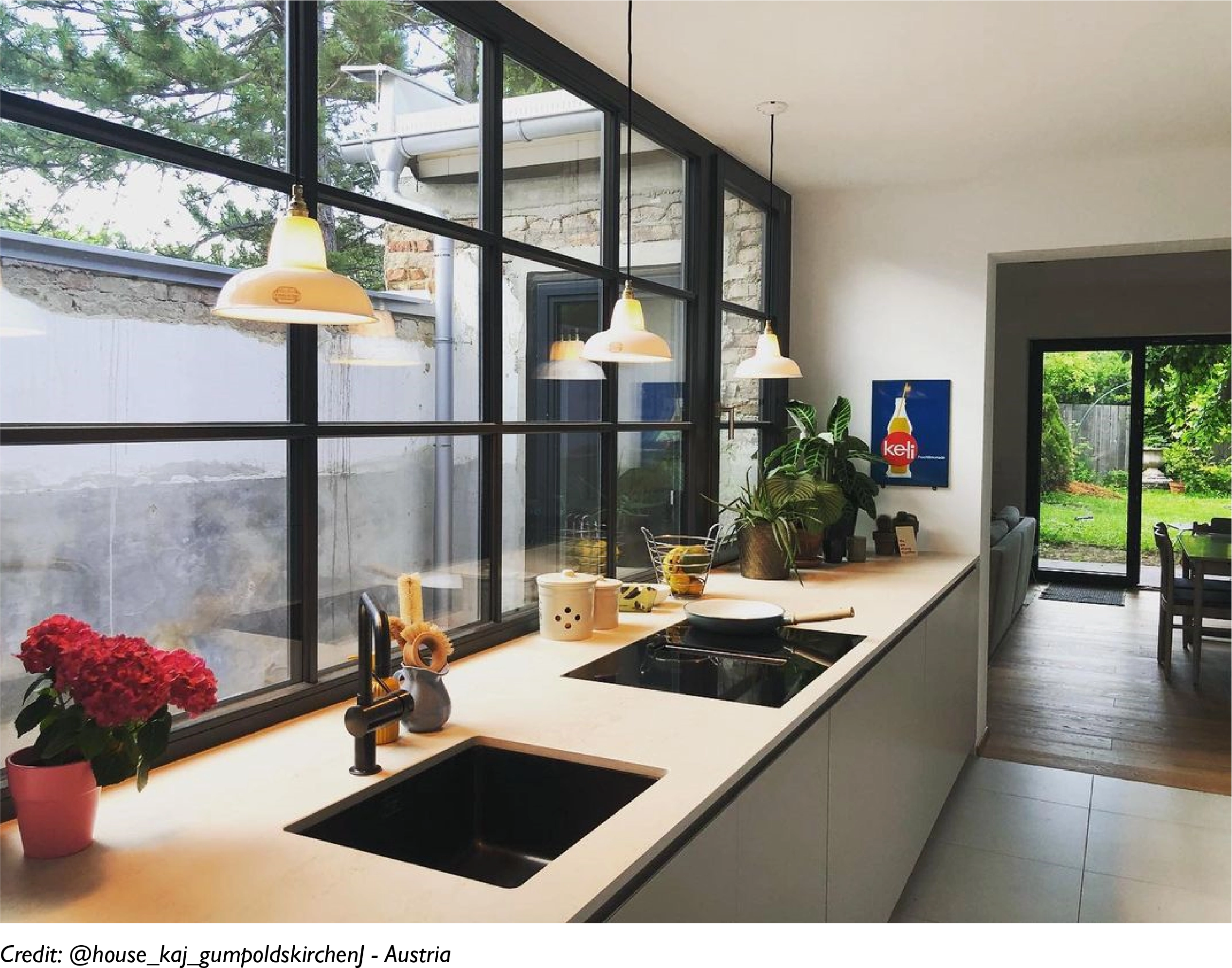 A row of 3 Silhouette Bone China lampshades hanging over a kitchen sink and a counter top in an open plan kitchen