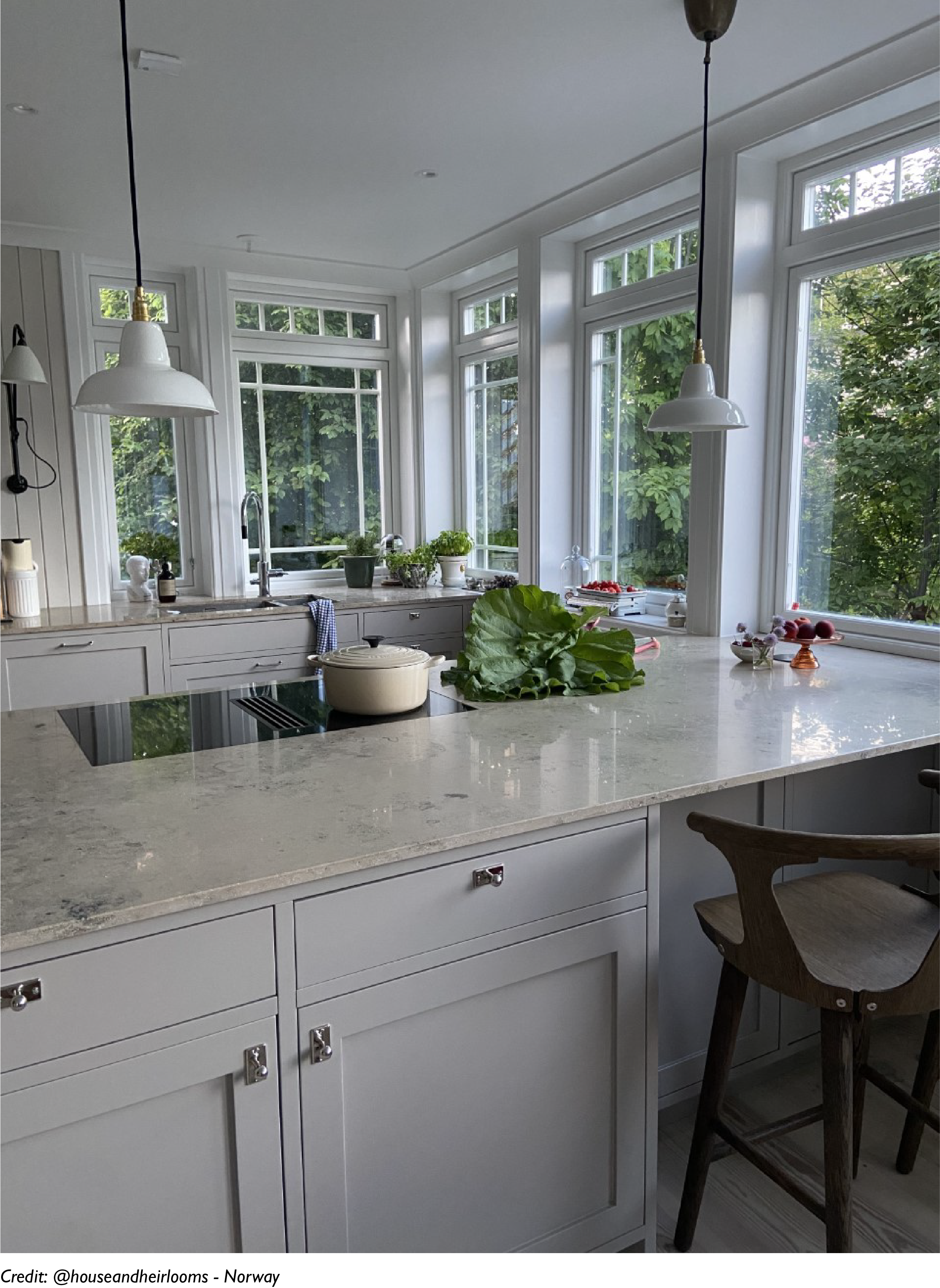Two Silhouette Bone China lampshades hang over a marble tabletop in a kitchen