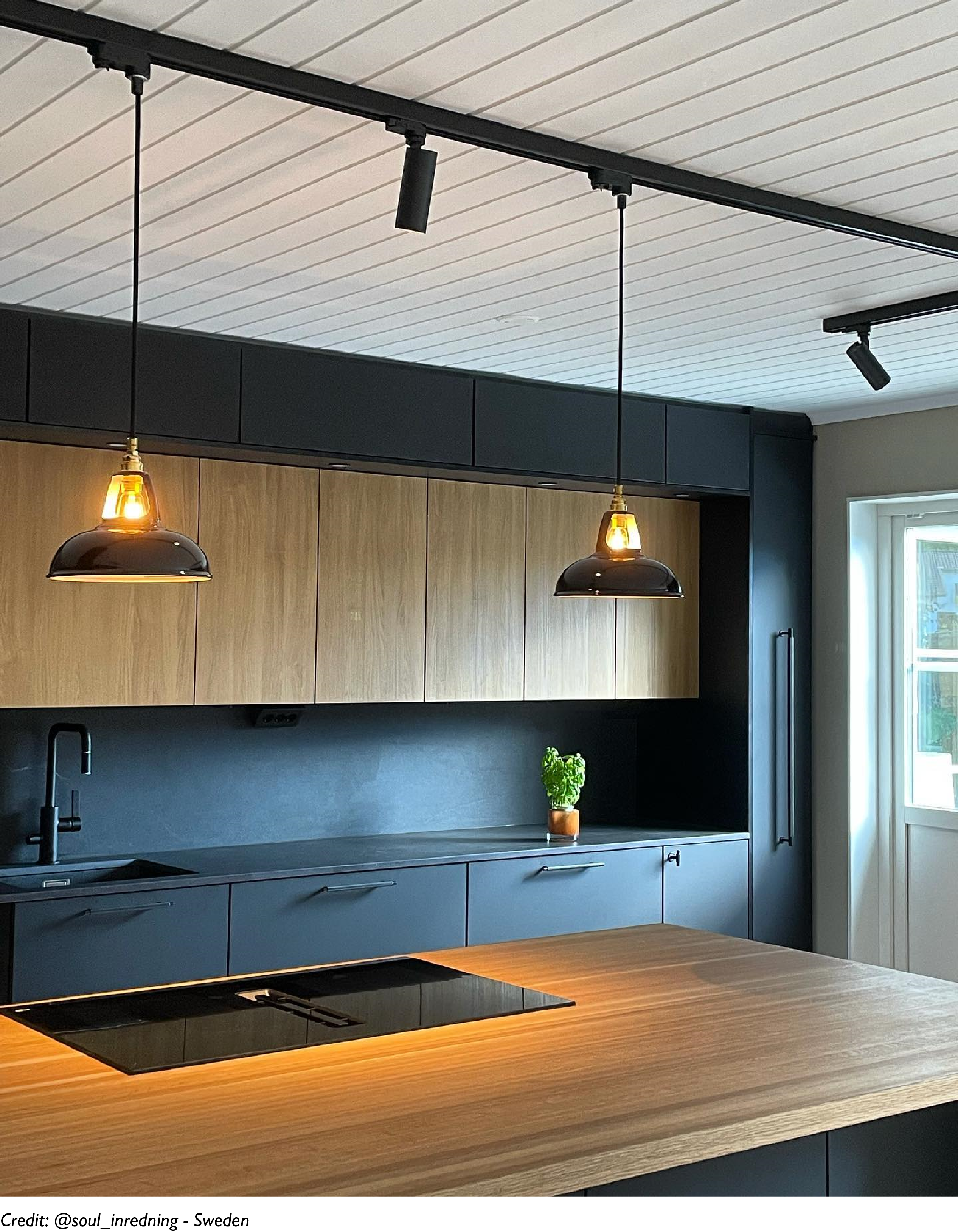 Two Pewter lampshades hang over a kitchen island