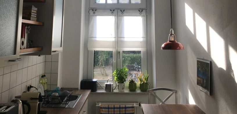 A breakfast table is illuminated by a Coolicon Original Terracotta lampshade