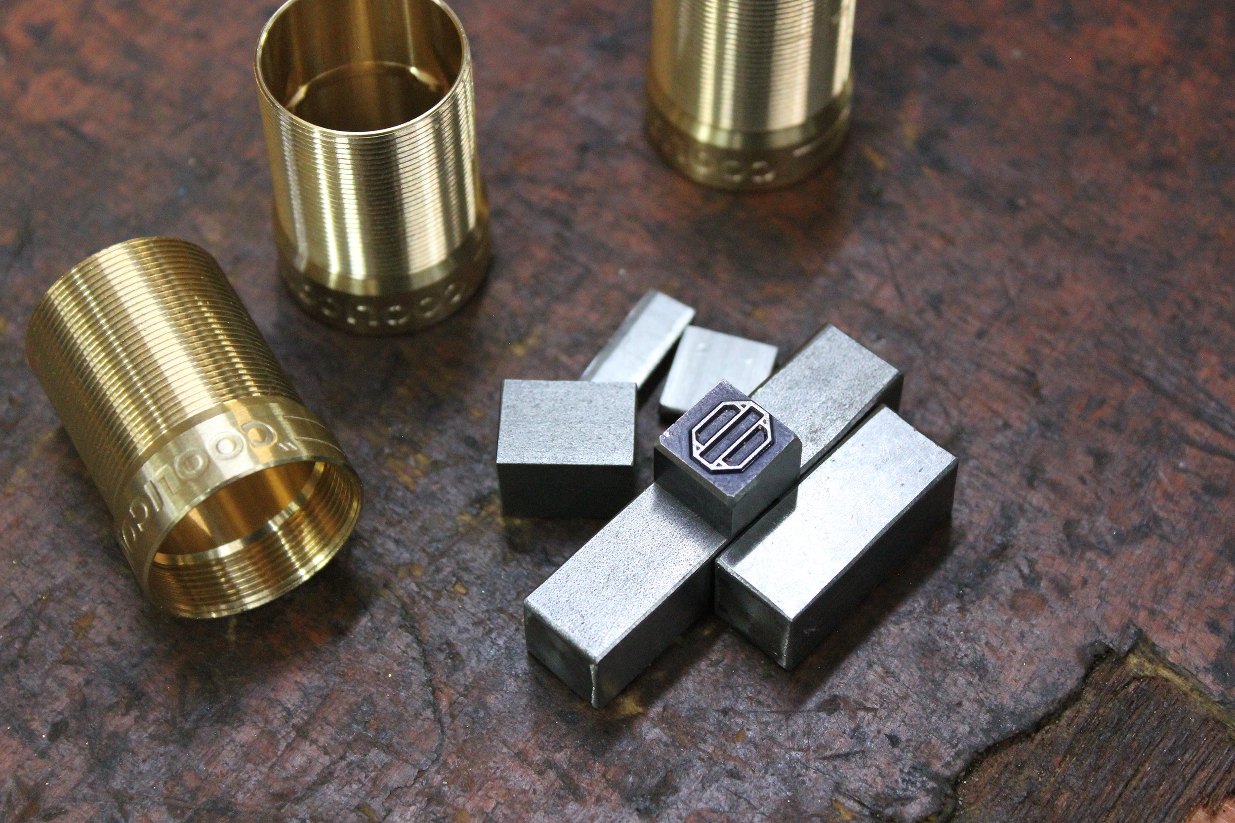 A tube of solid brass with thread and the word 